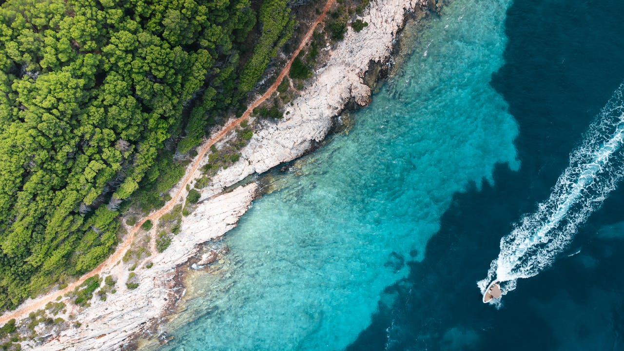 A stunning aerial view of the coastline in Split, Croatia with clear turquoise waters.